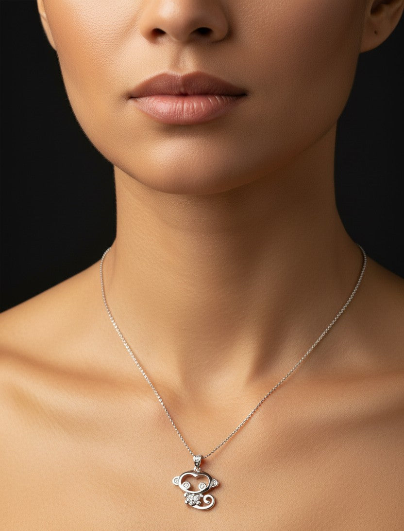 Silver necklace with a floral pendant on a model against a black background